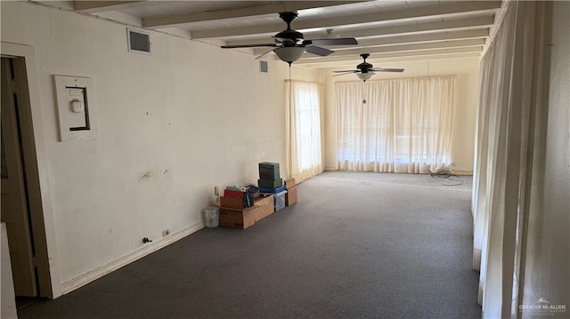 interior space with visible vents, beamed ceiling, baseboards, and ceiling fan