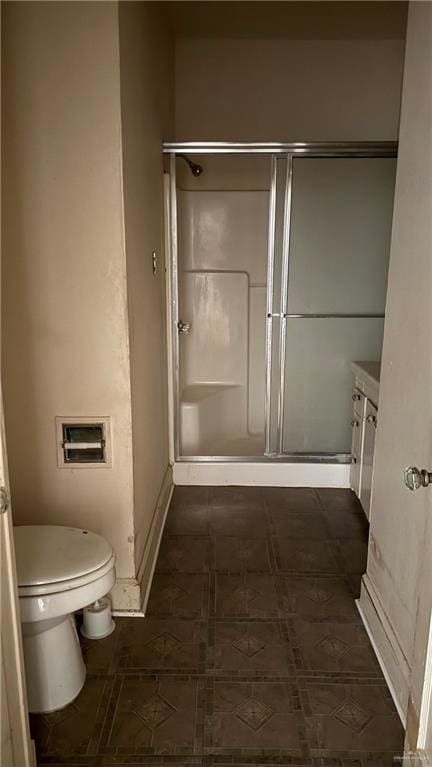 full bathroom with vanity, toilet, and a stall shower