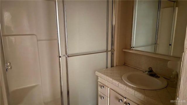 bathroom with an enclosed shower and vanity