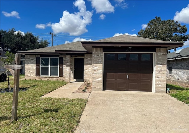 403 Gemini St, Mission, TX 78572 - view of front of home with brick siding, concrete driveway, an attached garage, a front yard, and a shingled roof
