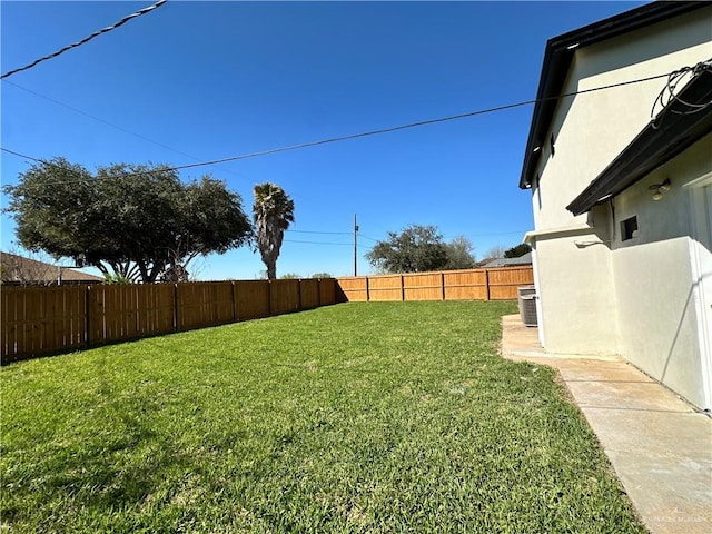 view of yard with a fenced backyard and central air condition unit