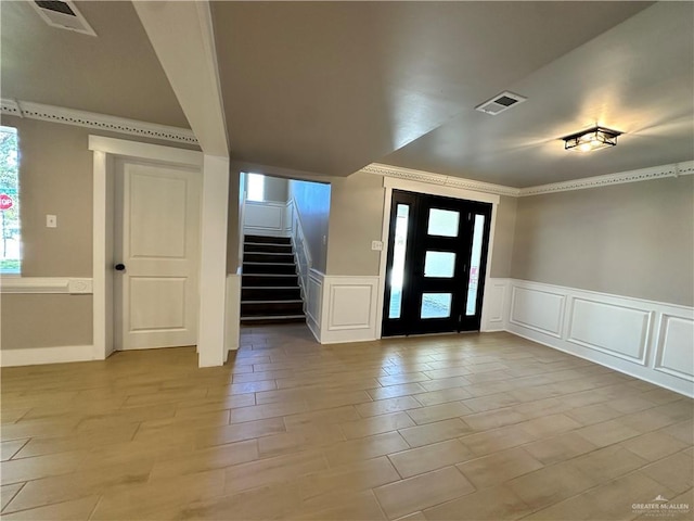 foyer with visible vents, plenty of natural light, and stairway