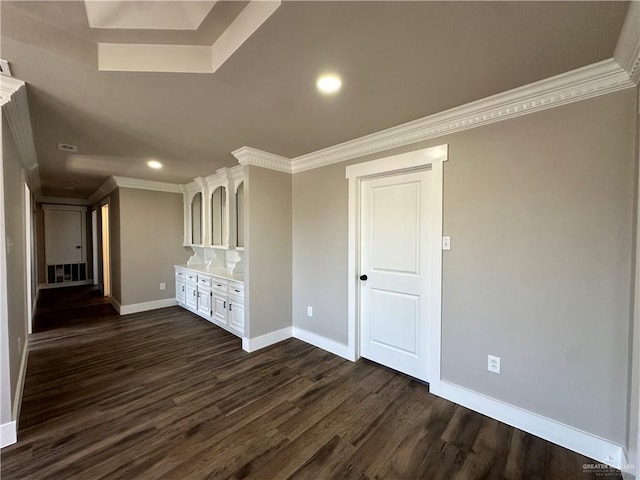 unfurnished living room featuring recessed lighting, dark wood-style flooring, crown molding, and baseboards