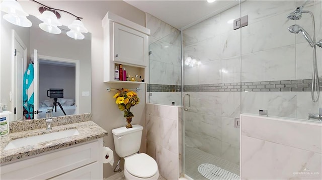 bathroom with vanity, toilet, and a stall shower