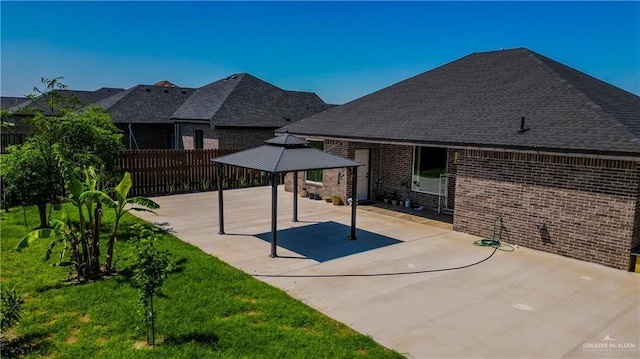 view of patio / terrace with fence and a gazebo