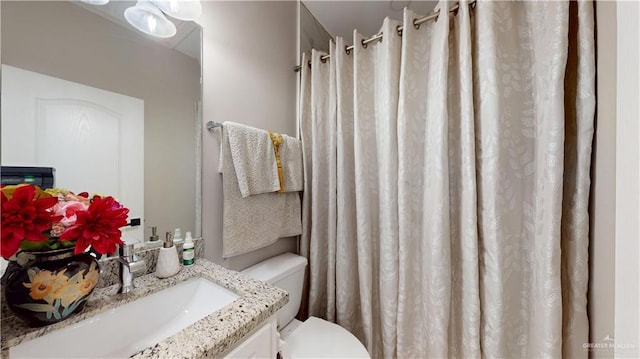 bathroom with vanity, toilet, and a shower with curtain
