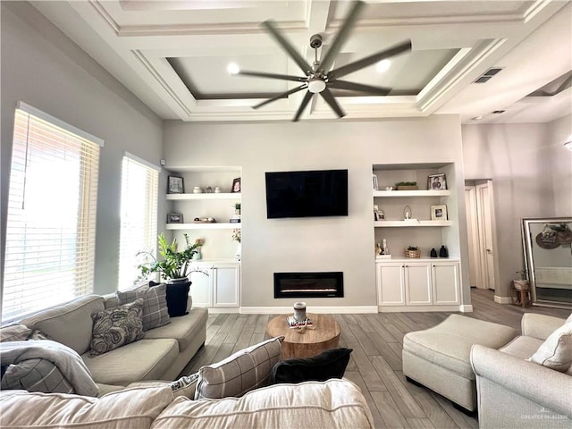 living room featuring coffered ceiling, ceiling fan, light hardwood / wood-style flooring, and built in shelves