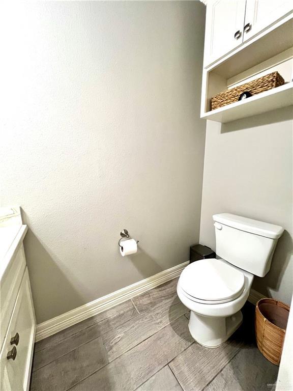 bathroom featuring toilet and vanity