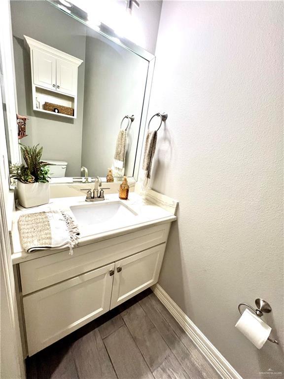 bathroom featuring toilet and vanity