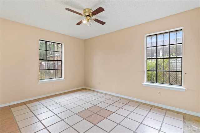 2117 S 30 1/2 St, Mcallen, TX 78503 - spare room with ceiling fan, a textured ceiling, light tile patterned flooring, and baseboards