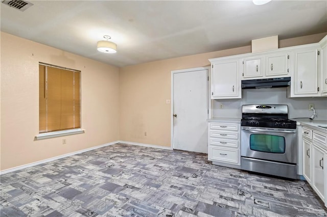 2117 S 30 1/2 St, Mcallen, TX 78503 - kitchen with stainless steel gas range oven, under cabinet range hood, white cabinets, light countertops, and baseboards