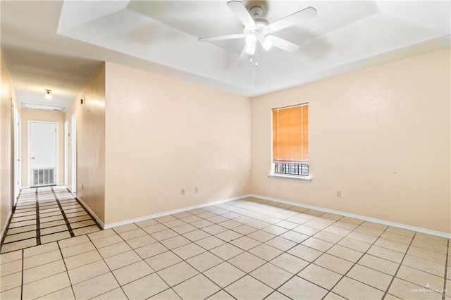 2117 S 30 1/2 St, Mcallen, TX 78503 - unfurnished room featuring a tray ceiling, light tile patterned floors, a ceiling fan, and baseboards