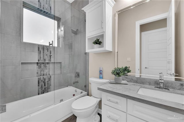 full bathroom with vanity, enclosed tub / shower combo, and toilet