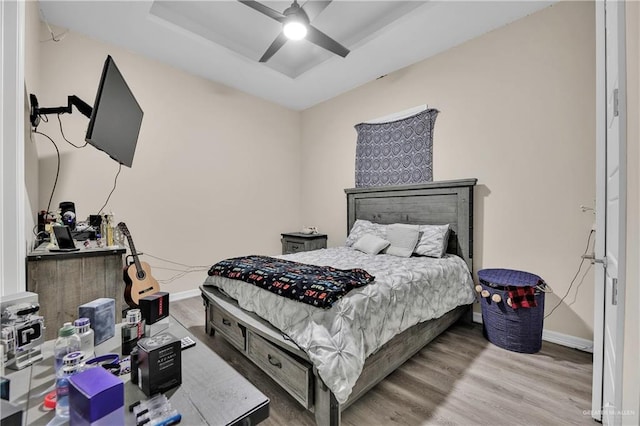 bedroom with ceiling fan and wood-type flooring