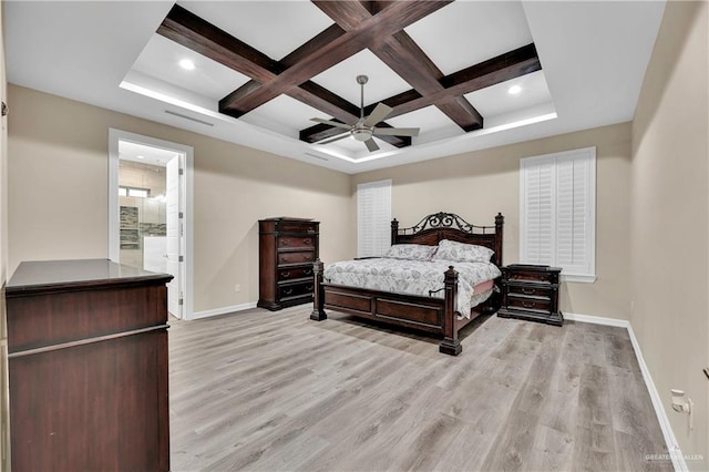 bedroom with coffered ceiling, ceiling fan, light wood-type flooring, connected bathroom, and beamed ceiling