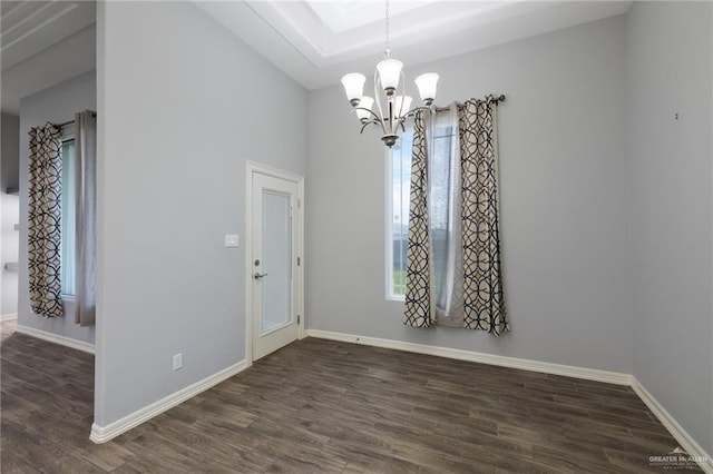 interior space featuring dark hardwood / wood-style floors and an inviting chandelier