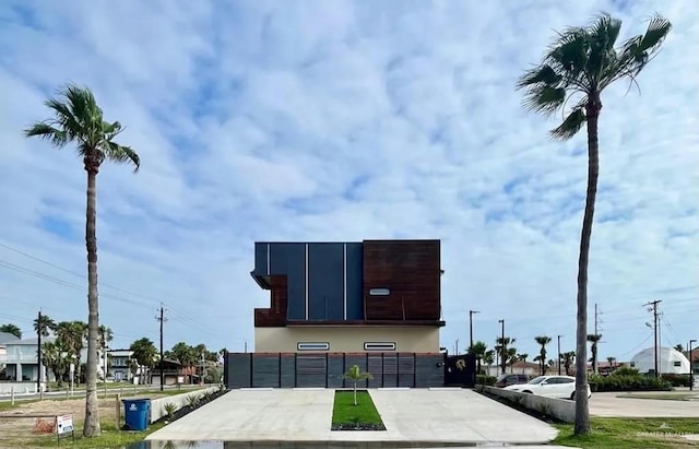 exterior details featuring concrete driveway and stucco siding