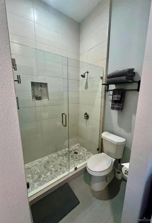 full bath with a shower stall and toilet