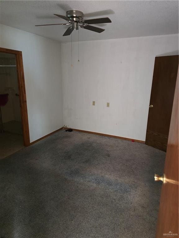 empty room with carpet and ceiling fan