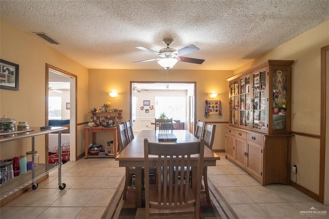 dining room with light tile patterned floors and a textured ceiling