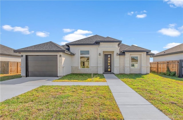 prairie-style home with a garage and a front lawn