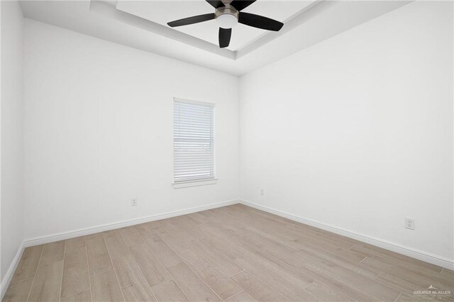 901 E Yuma Ave Unit 606, Mcallen, TX 78503 - empty room with light wood-style floors, a raised ceiling, and baseboards