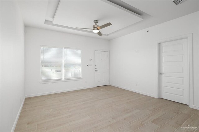 901 E Yuma Ave Unit 606, Mcallen, TX 78503 - unfurnished room with visible vents, baseboards, ceiling fan, a raised ceiling, and light wood finished floors