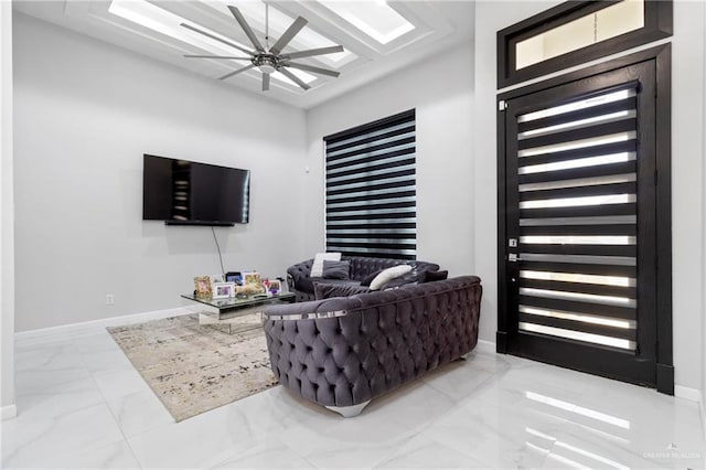 living room featuring marble finish floor, ceiling fan, and baseboards