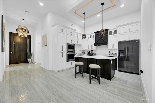 kitchen featuring appliances with stainless steel finishes, a breakfast bar, pendant lighting, a center island, and white cabinetry