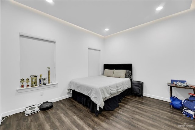 bedroom with dark wood-type flooring