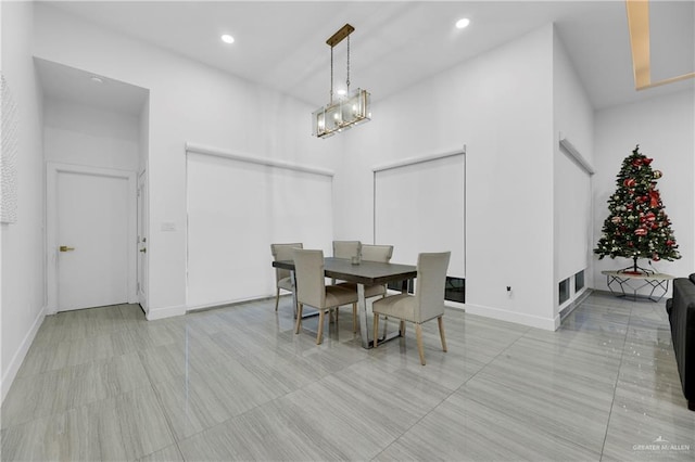 dining room featuring a towering ceiling