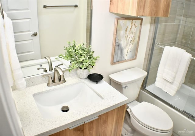 full bathroom featuring vanity, toilet, and enclosed tub / shower combo