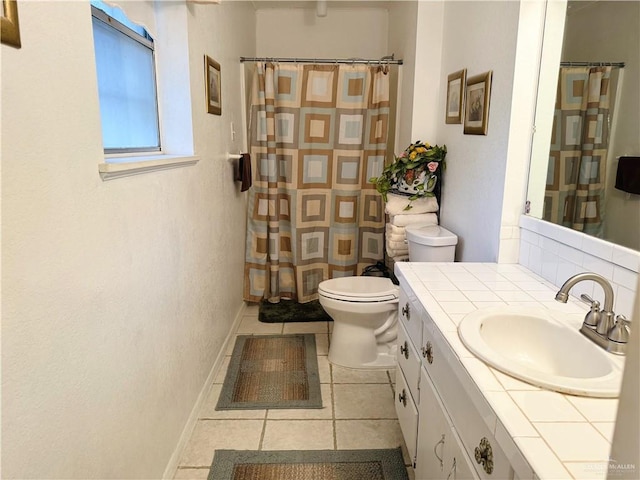 bathroom featuring vanity, tile patterned flooring, and toilet