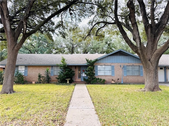 single story home with a garage and a front yard