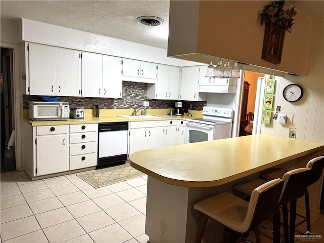 kitchen with white cabinetry, white appliances, and sink