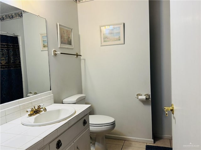 bathroom featuring tile patterned floors, toilet, and vanity