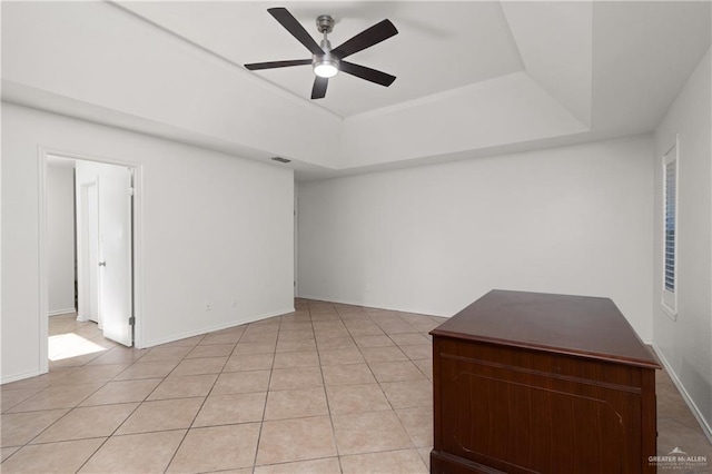 2702 Lazy Lake Dr, Harlingen, TX 78550 - spare room with a raised ceiling, ceiling fan, and light tile patterned flooring