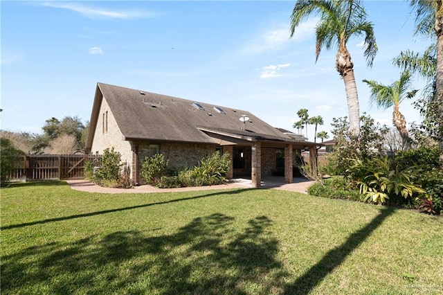 2702 Lazy Lake Dr, Harlingen, TX 78550 - back of property with a patio, brick siding, and roof with shingles