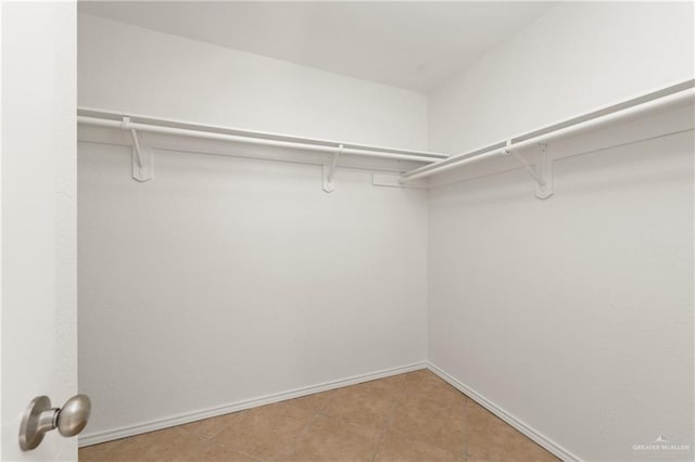 2702 Lazy Lake Dr, Harlingen, TX 78550 - walk in closet with tile patterned flooring