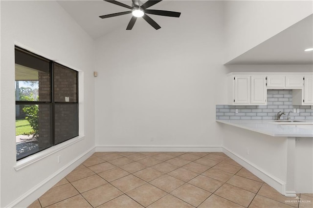 2702 Lazy Lake Dr, Harlingen, TX 78550 - unfurnished dining area with ceiling fan, high vaulted ceiling, and light tile patterned floors