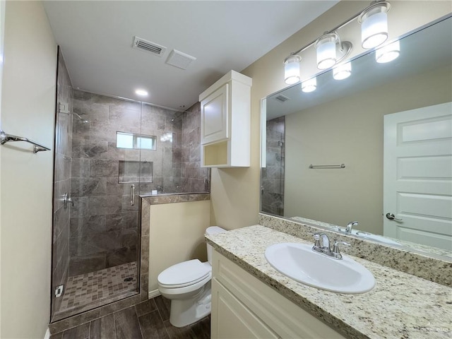 bathroom with vanity, toilet, and walk in shower