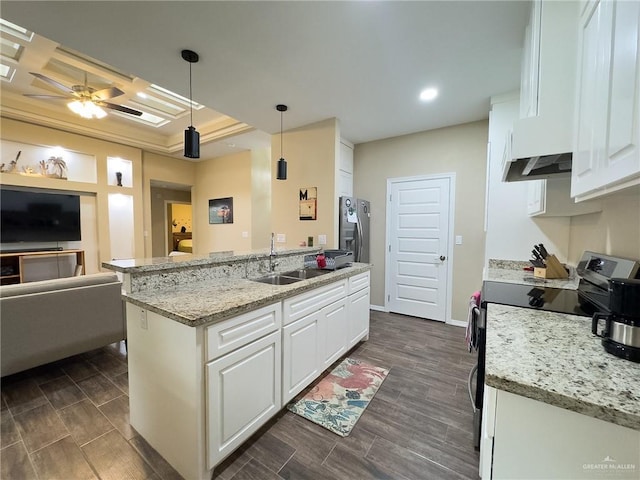 kitchen featuring sink, stainless steel appliances, an island with sink, decorative light fixtures, and white cabinets