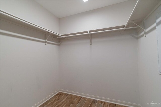 14451 Chalk Ridge Dr, Mcallen, TX 78504 - walk in closet with dark wood-type flooring