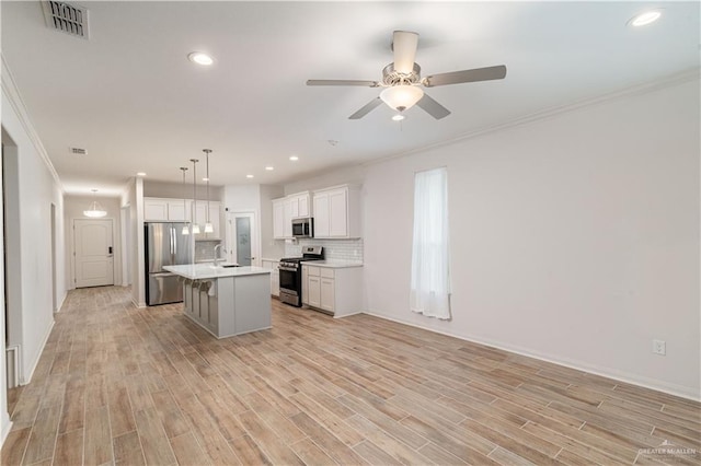14451 Chalk Ridge Dr, Mcallen, TX 78504 - kitchen with stainless steel appliances, a sink, ceiling fan, ornamental molding, and open floor plan