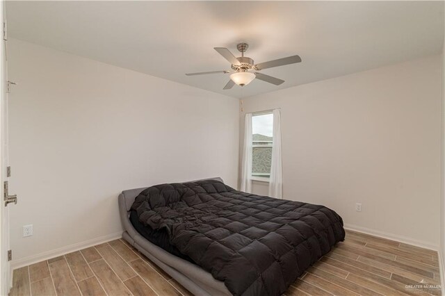 14451 Chalk Ridge Dr, Mcallen, TX 78504 - bedroom featuring light wood finished floors, baseboards, and a ceiling fan