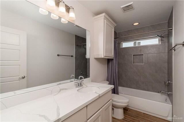 14451 Chalk Ridge Dr, Mcallen, TX 78504 - full bath featuring toilet, vanity, shower / bathtub combination with curtain, wood finished floors, and recessed lighting