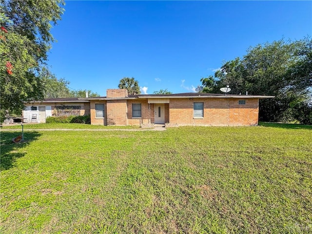 ranch-style home featuring a front yard and brick siding