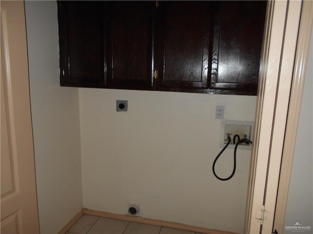 laundry room featuring hookup for an electric dryer, light tile patterned flooring, cabinets, and washer hookup