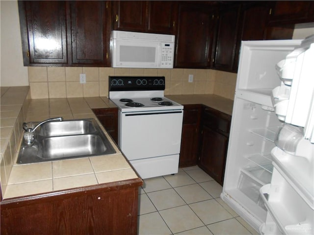 kitchen with white appliances, sink, decorative backsplash, tile counters, and light tile patterned flooring