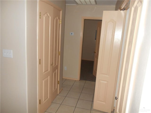 hall featuring light tile patterned flooring